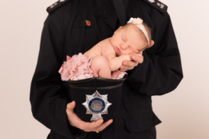 Beautiful baby in a policeman's helmet